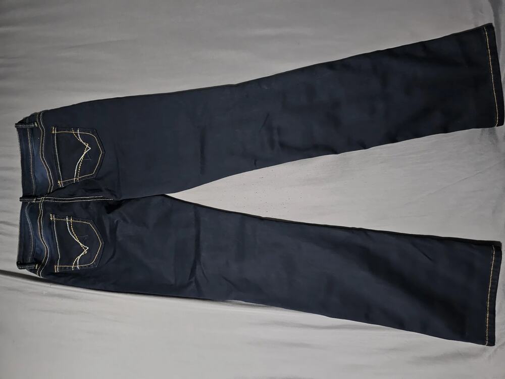 Dark wash denim jeans with contrast stitching and embroidered back pockets